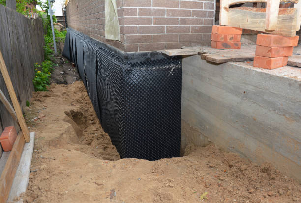 SJ Waterproofing Pros technician performing targeted Wet Basement Repair assessment in Midland, PA